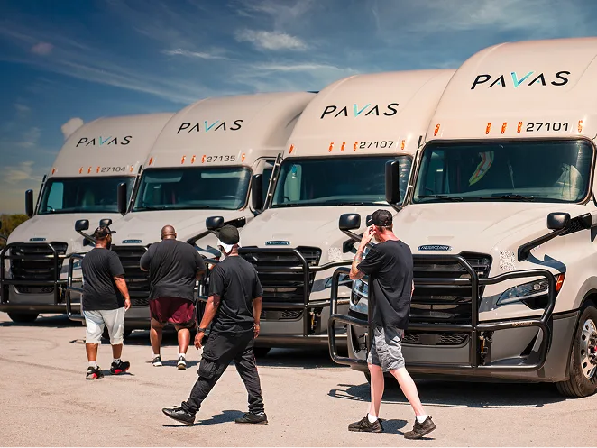Pavas trailer parked at a logistics yard at dusk