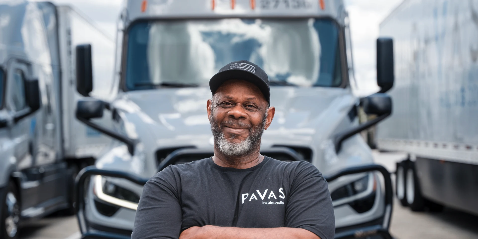 Pavas driver in front of fleet trucks